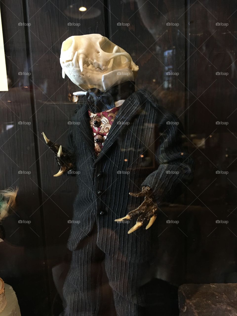 Taxidermy animal creation with a skeleton creature in a suit with bird feet