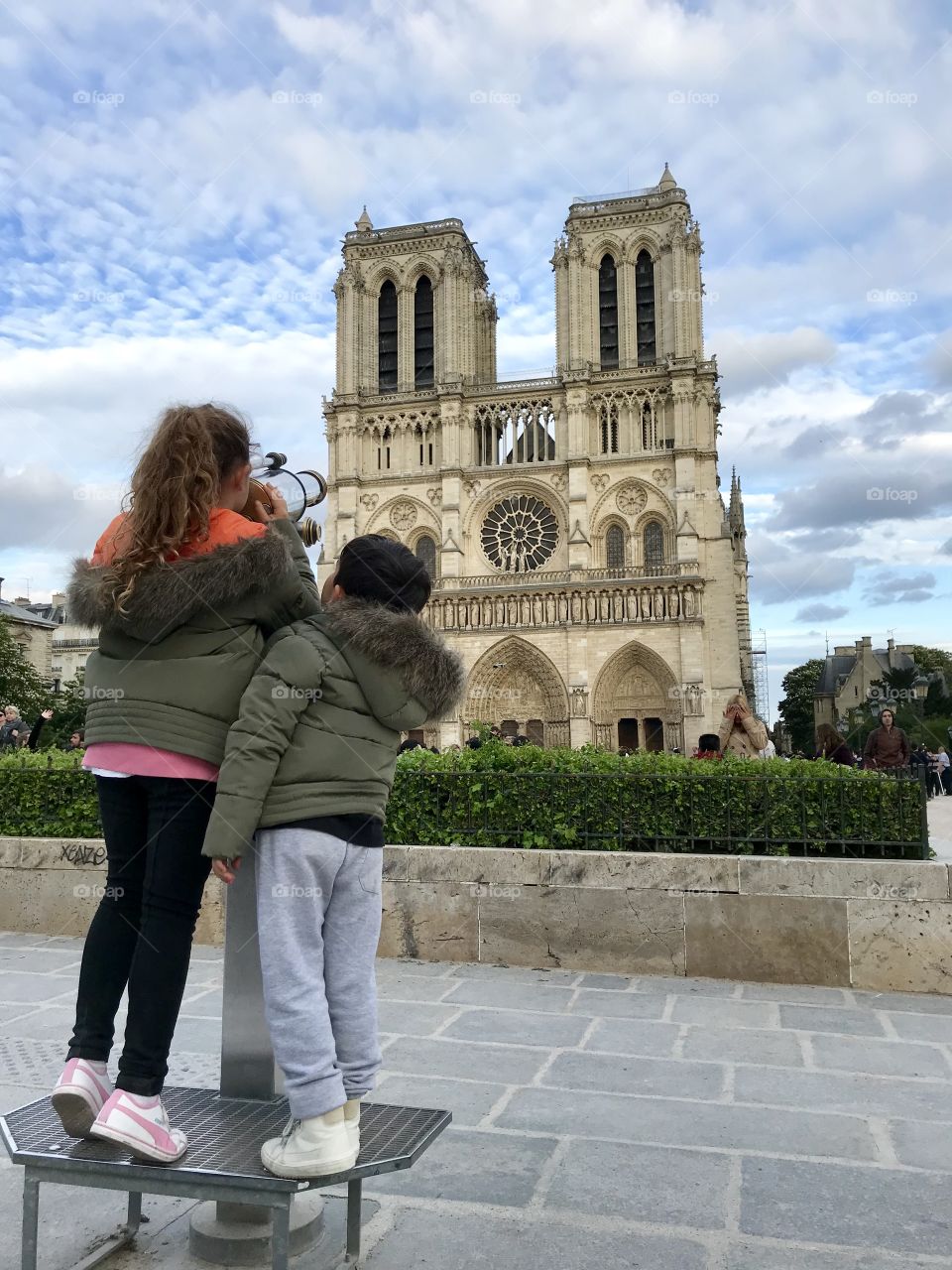 Discovering Paris. Kids looking at Notre-Dame de Paris Cathedral 