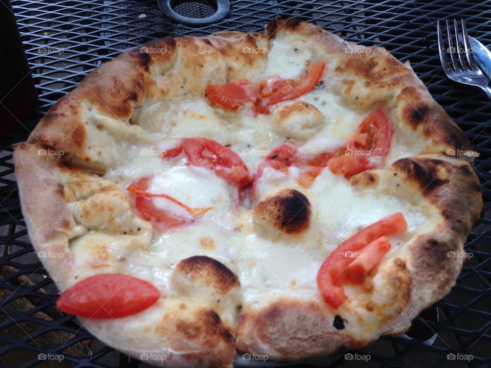 Pizza from The Wedge in OKC has the best wood fired pizzas. This one was amazing with Tomatoes, cheese, and garlic sauce. 