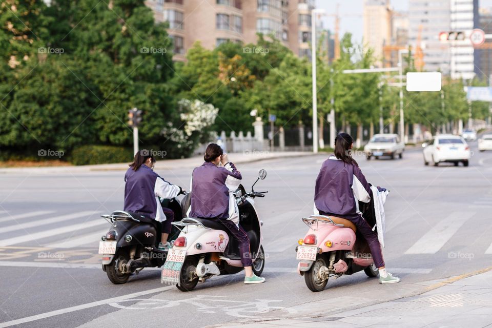 Girls riding on scooters 