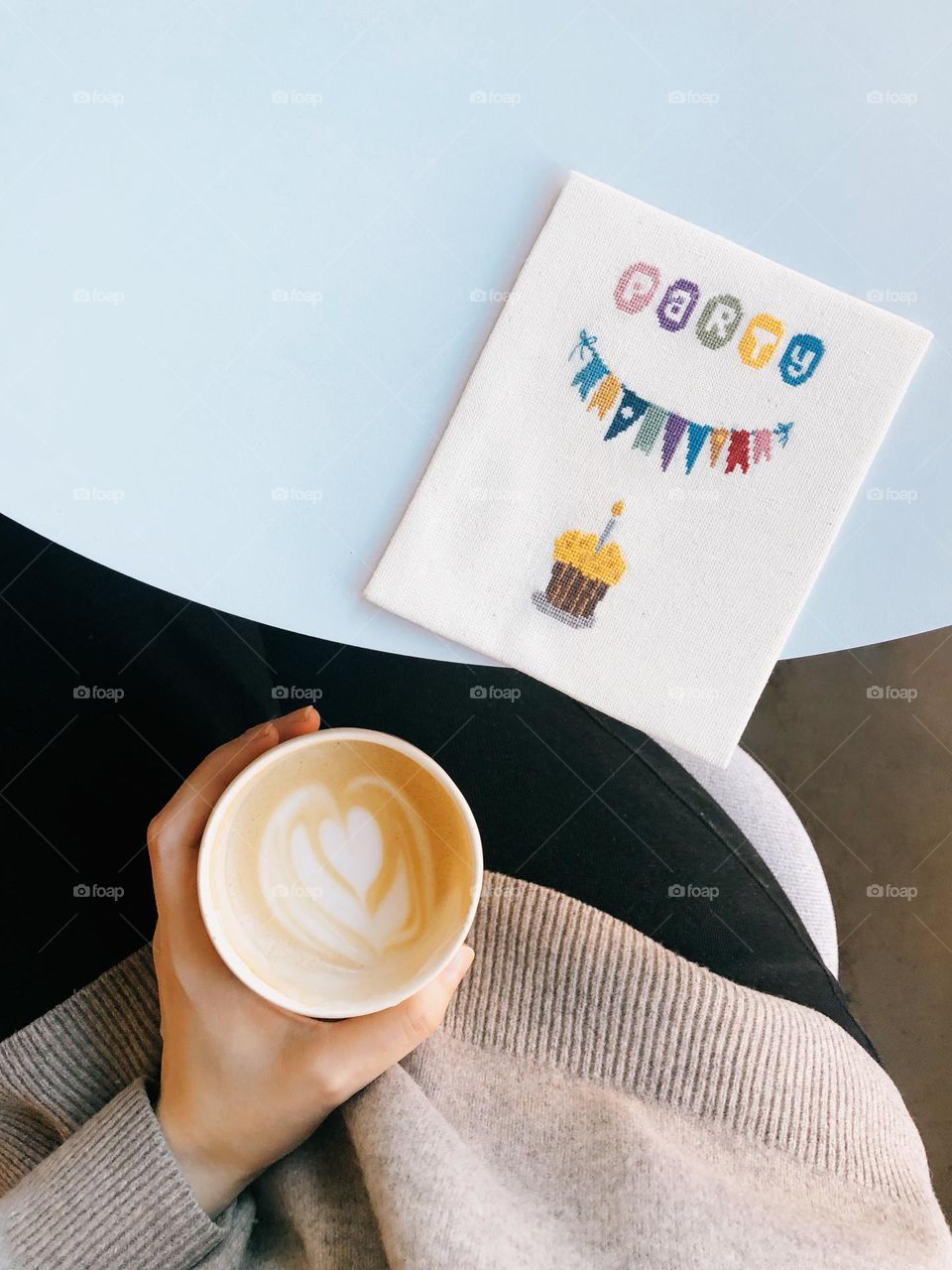 Coffee cup with cappuccino on woman hand