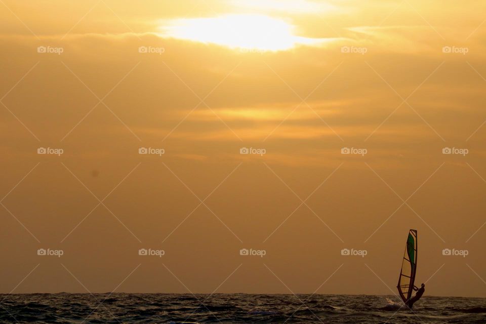 Wind surfer on sunset 