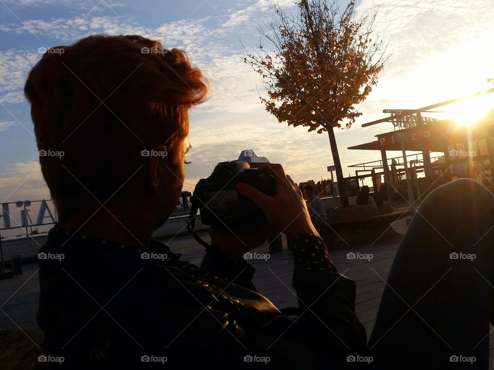 girl with short hair taking a picture