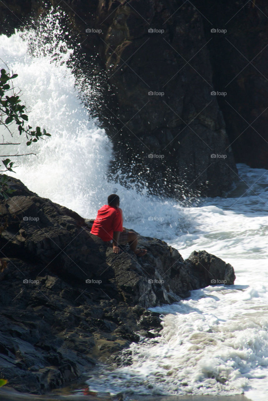 Watching waves crashing against rocks