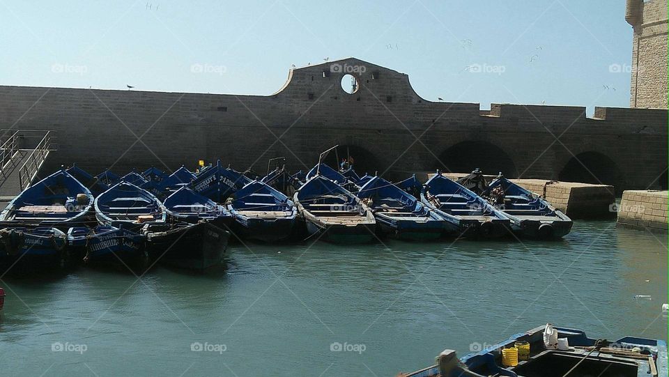 Flock of blue boats in the harbour at essaouira city.