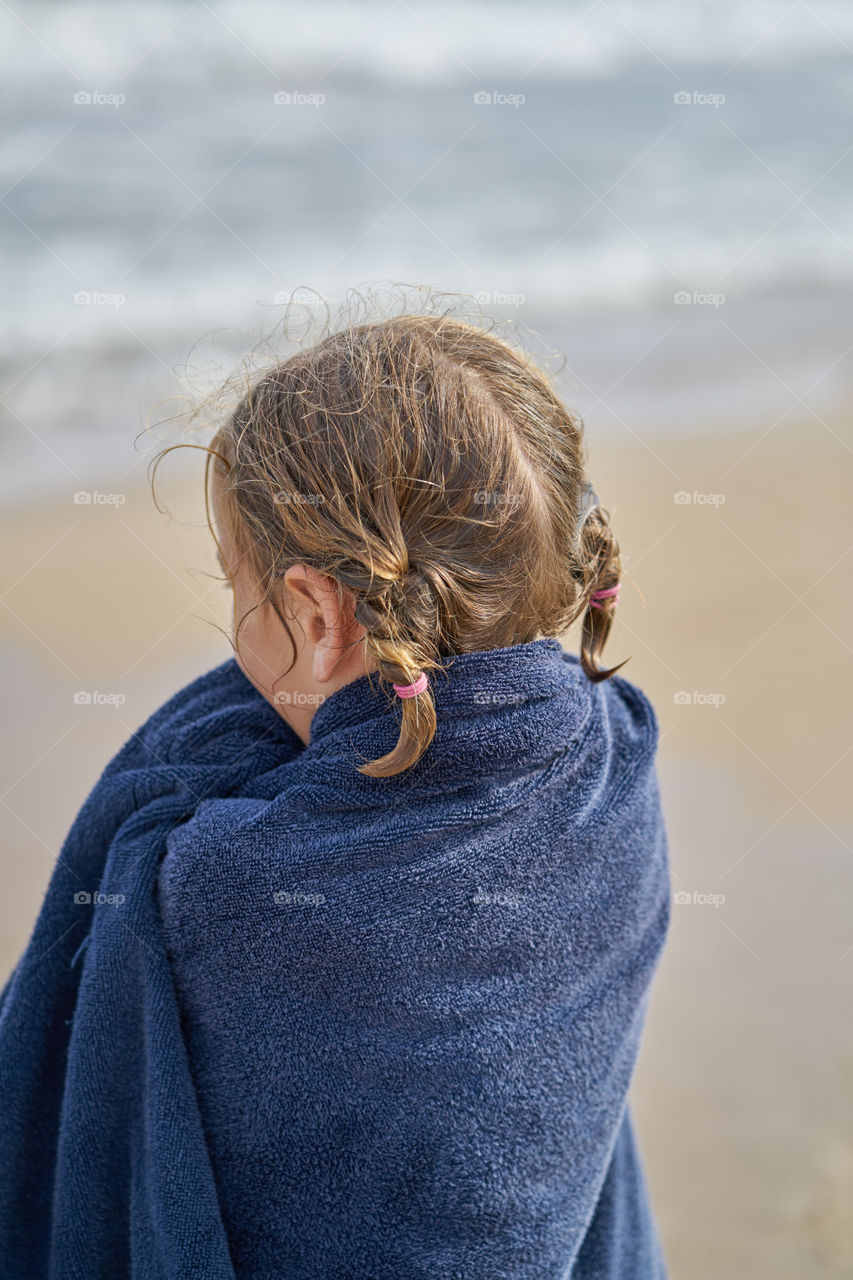 Rear view of a girl wrapped with towel