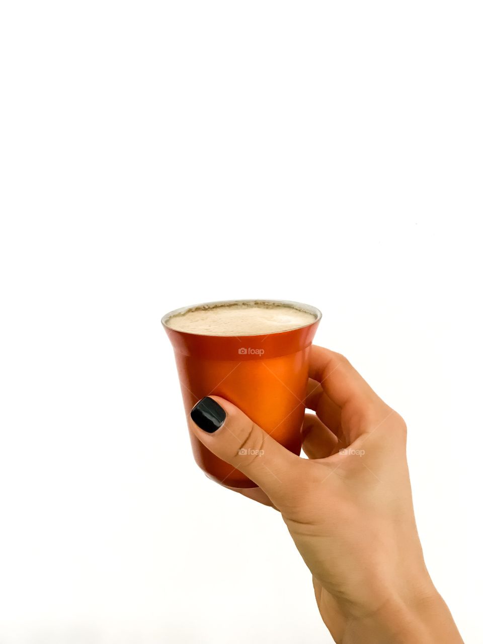 Nespresso moments: a hand holding a cup of morning coffee 