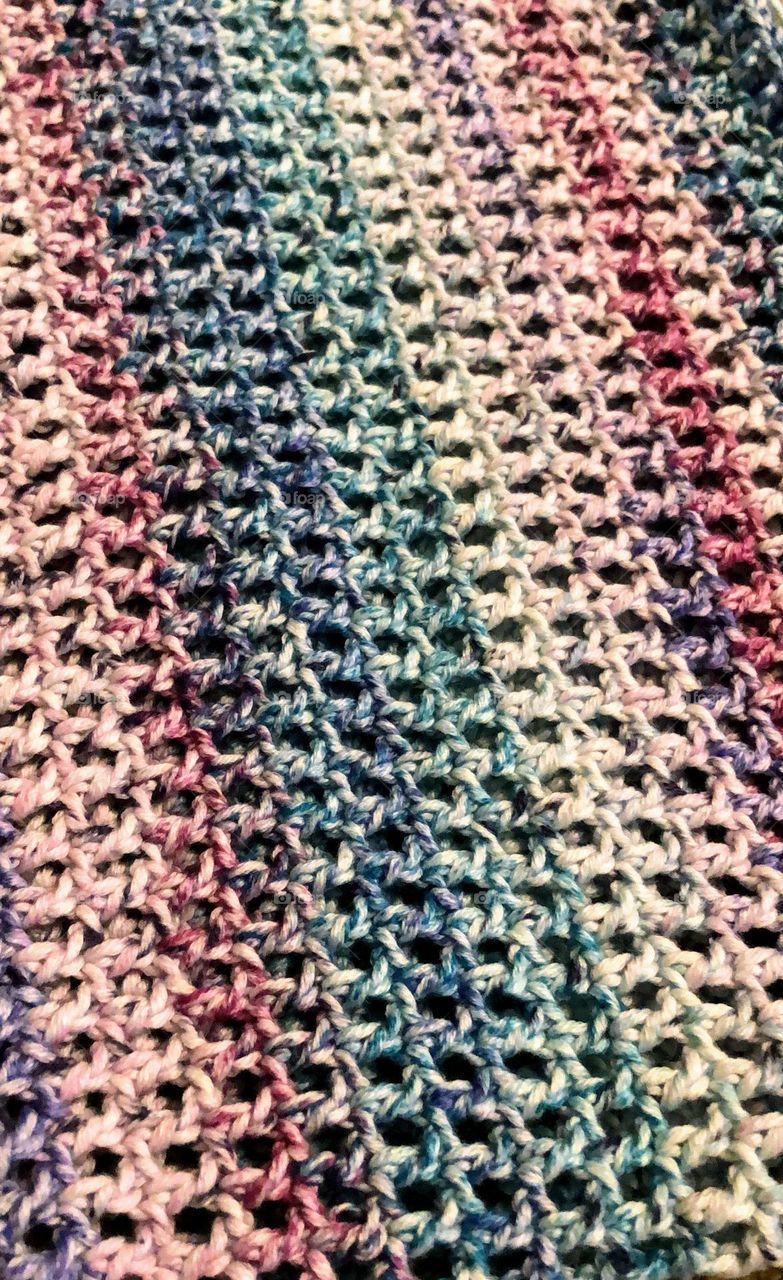 Close up of colorful handmade crocheted item surface