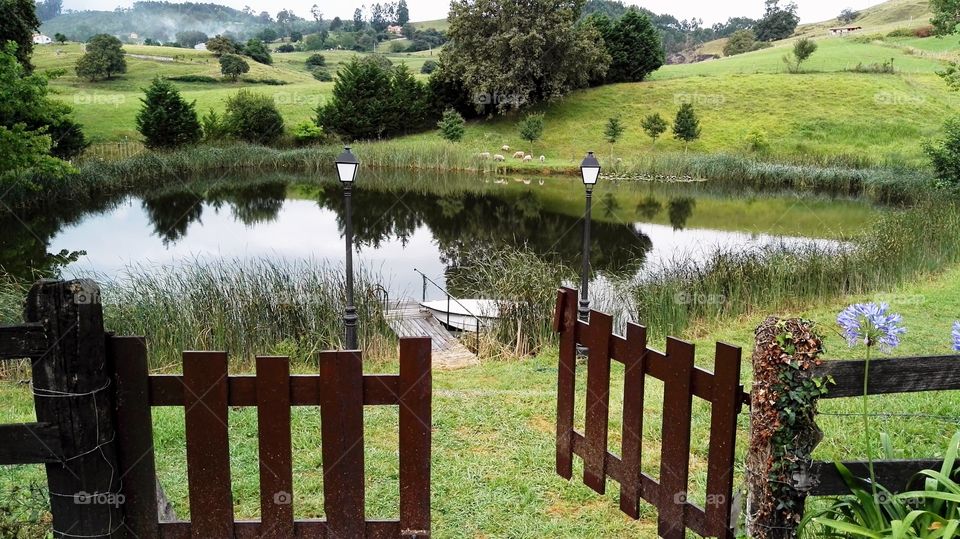 an open fence to go in, row in a boat in a beutiful lake with two lampposts