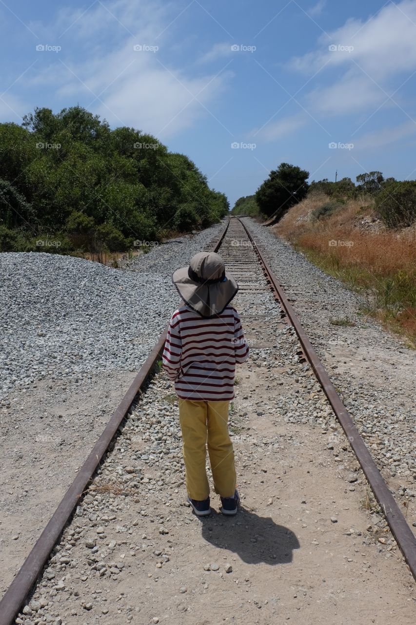 Person crossing train tracks