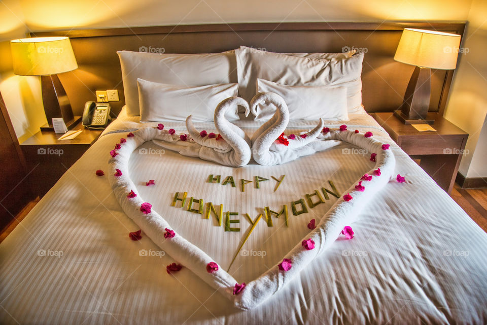 Happy honeymoon text on bed