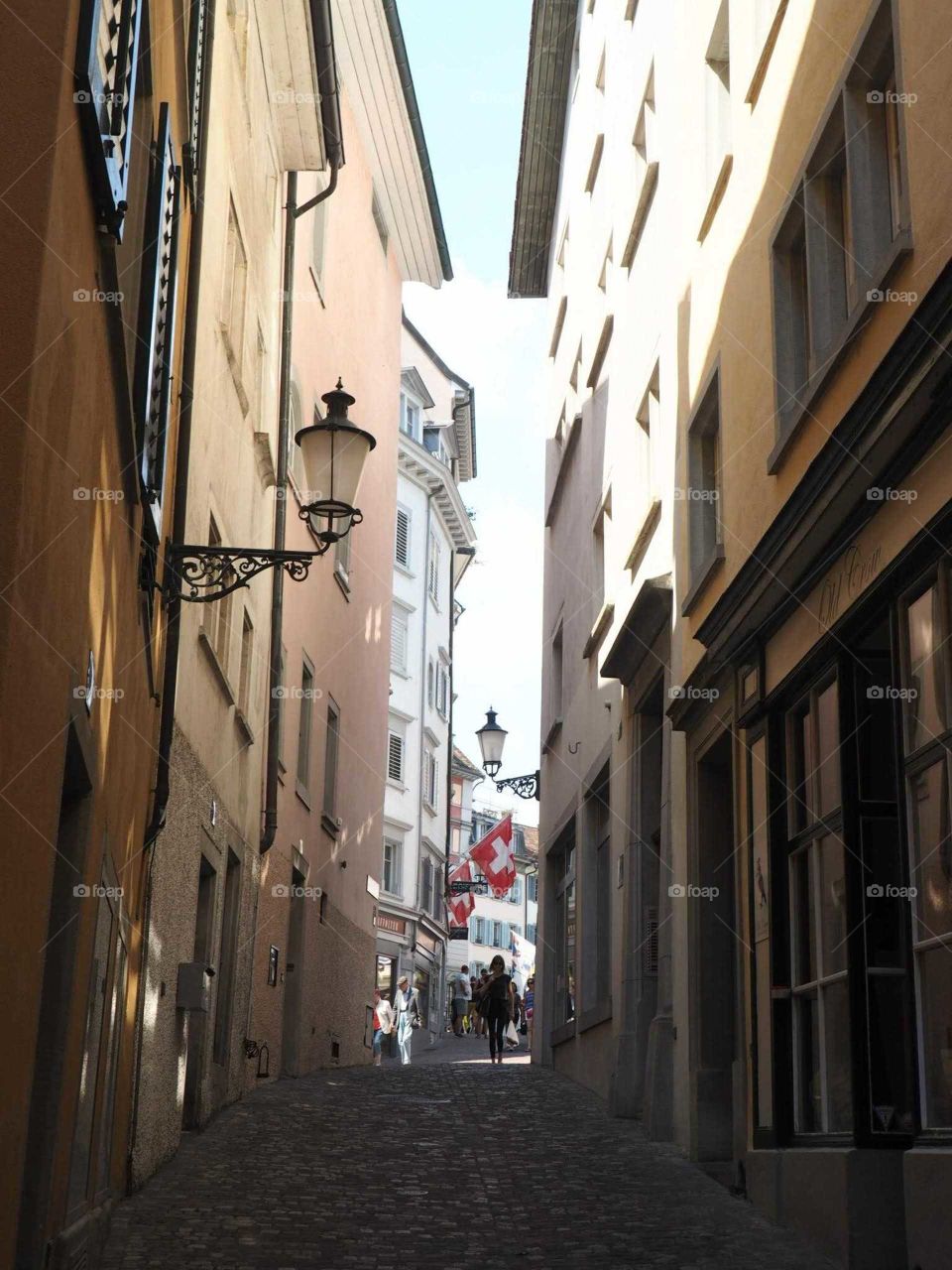 Cute and small street with colorful houses and flags in Zurich Switzerland