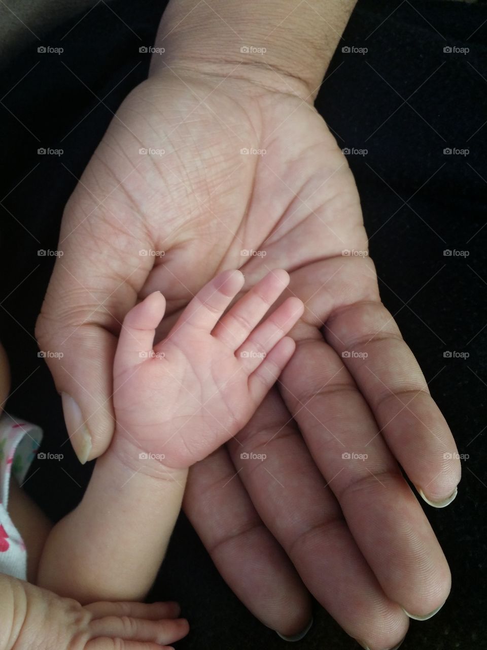 newborn hand in father's hand