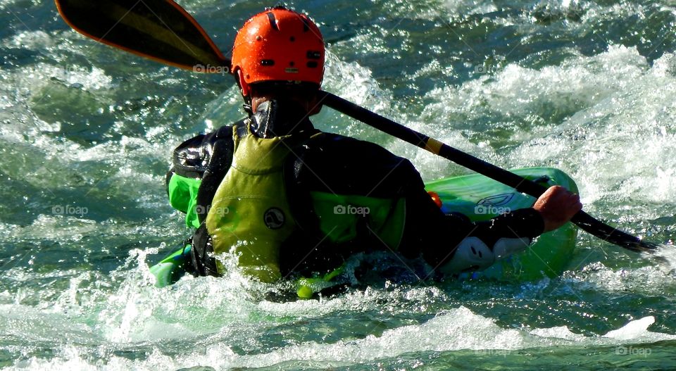 Colorful photo of a Kayaker negotiating the Chattooga river in South Carolina.