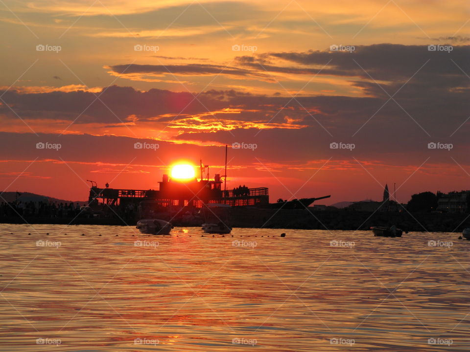 The sun. As the sun sets it created the ilusion of melding with the ship, Croatia.