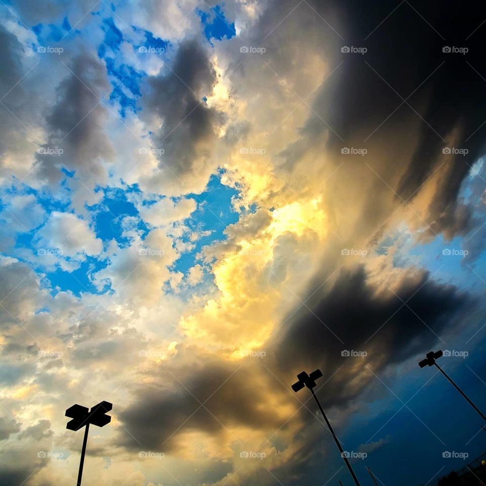 Beautiful clouds signal the calm before the storm over a city park