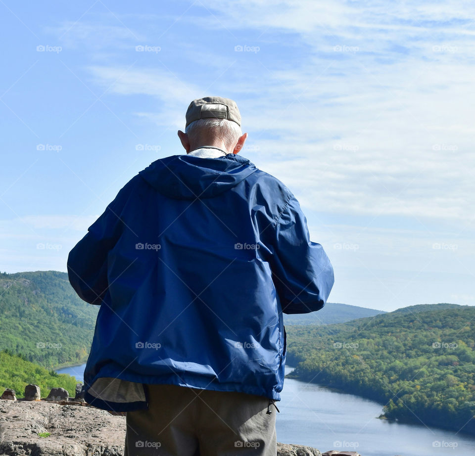Elderly man looking at scenic mountain view