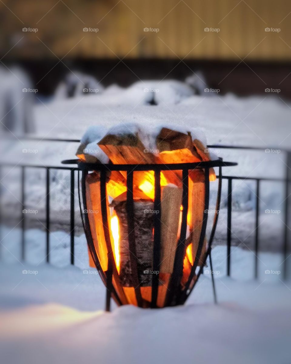 Burning fire wood in the snow