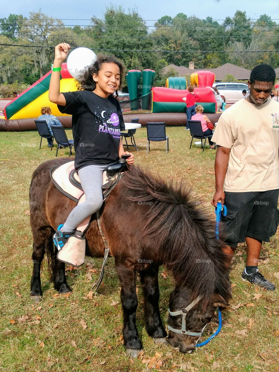 Child riding a pony named  Chocolate.