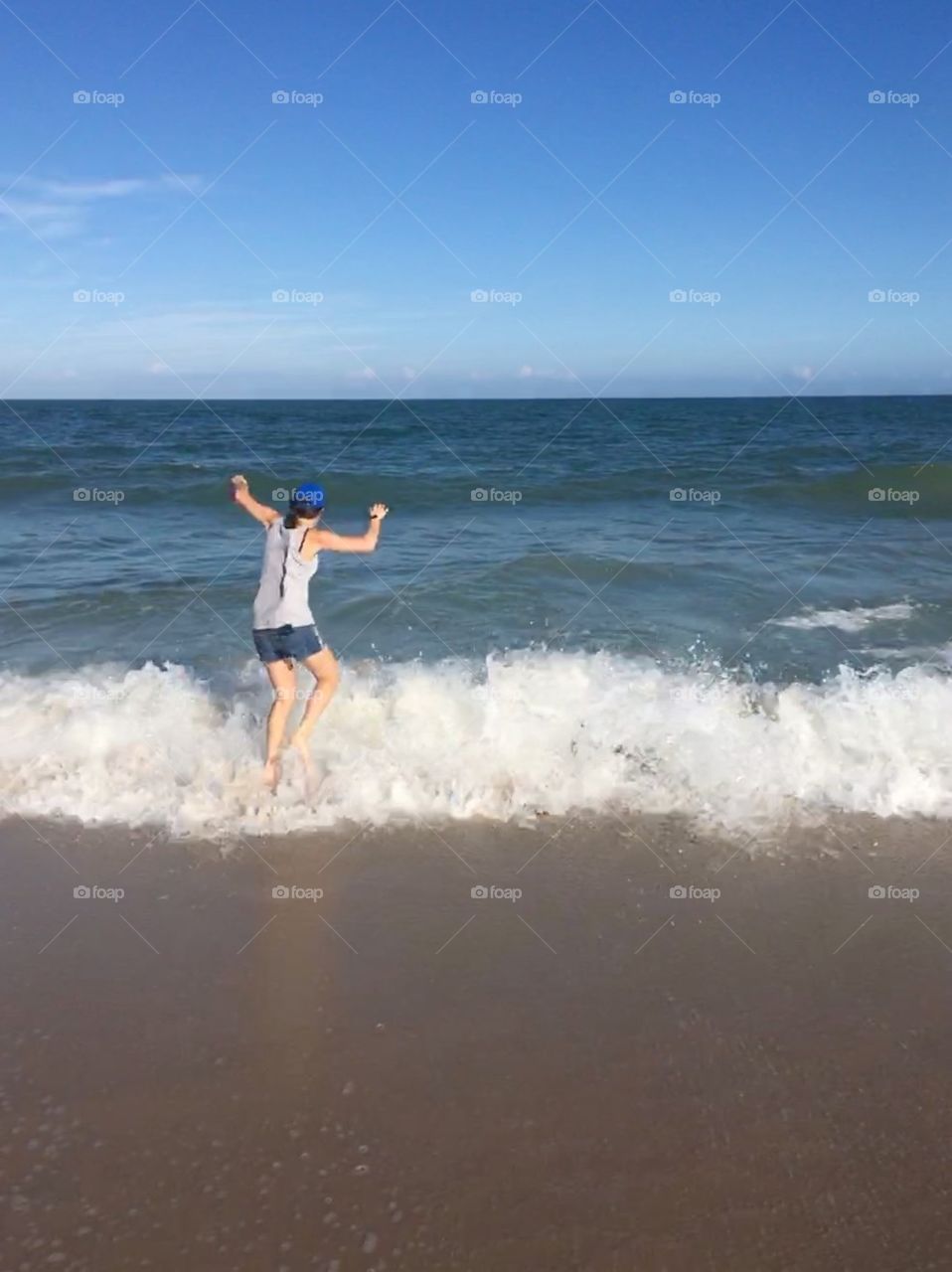 Girl running into the ocean in vero beach Florida, don't let the clear skies and shorts fool you, it's December and that water was COLD 