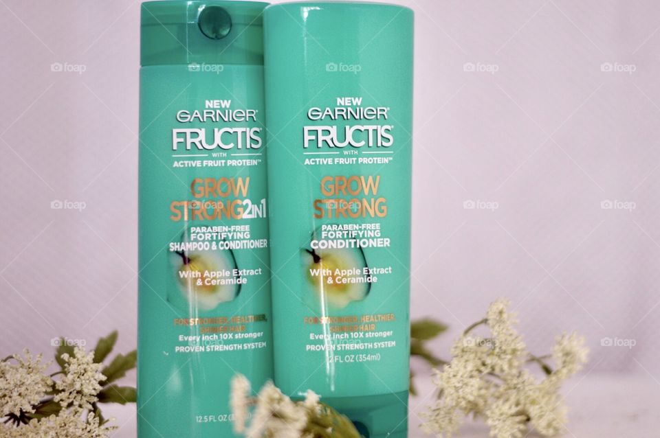 Garnier grow strong conditioner and shampoo Flat lay on a white background