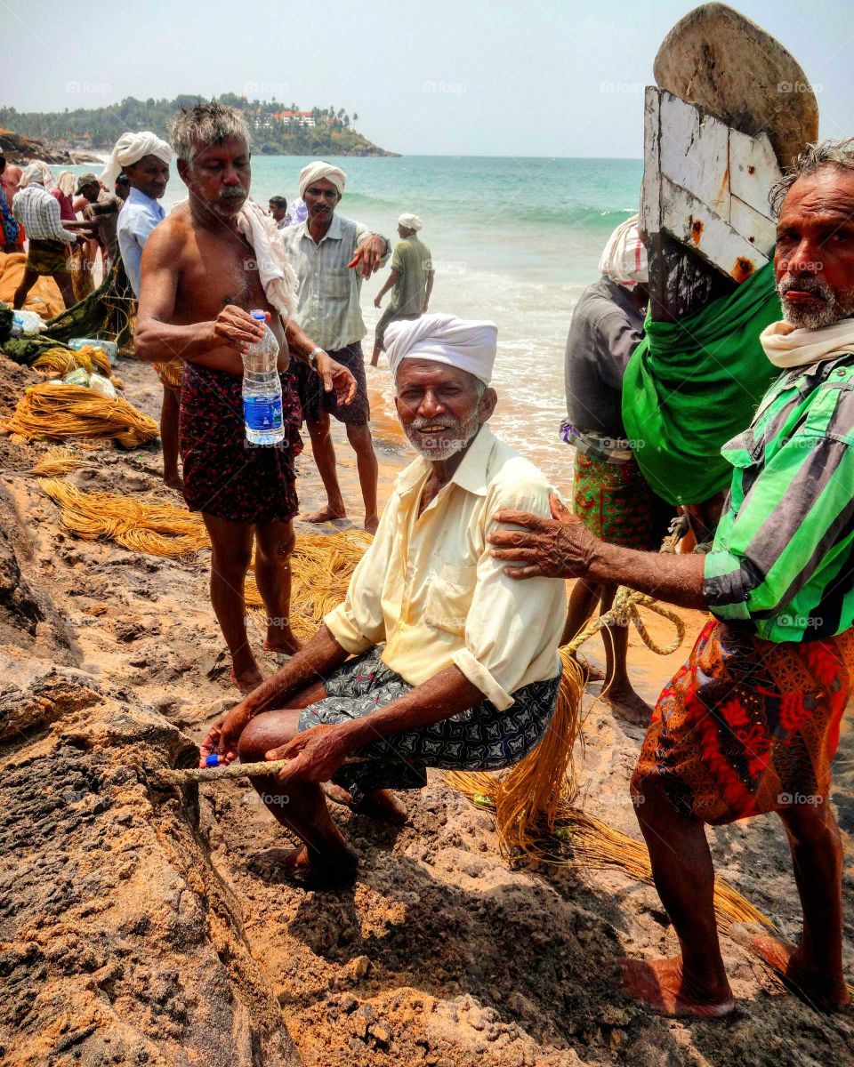 Group of Indian fishermen at coastline