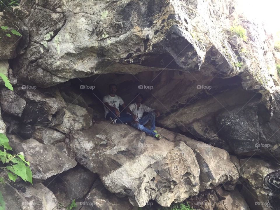 dark rocky mountain cave in forest