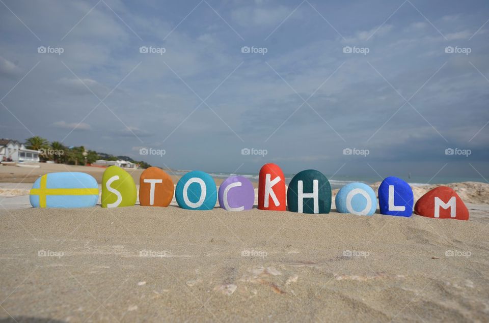 Colourful souvenir of Stockholm with stones on the sand