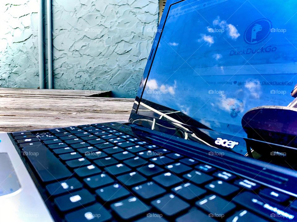 Working Online On The Laptop Writing Down A Start Of A Search On A Searching Engine Outside With Sky Reflection