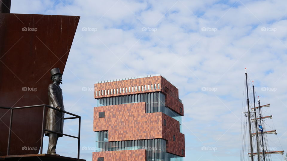 Sculpture, building and ship at the old port of Antwerp.
