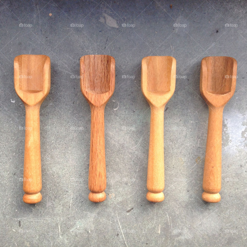 Four wooden spoons on a grey background 