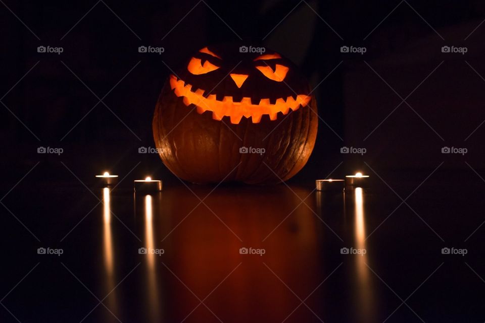 Halloween pumpkin head jack lantern with burning candles
