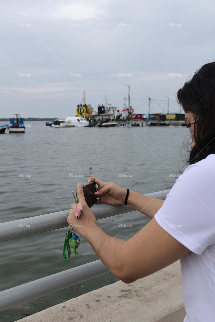 Taking a photo with a cell phone on the beach