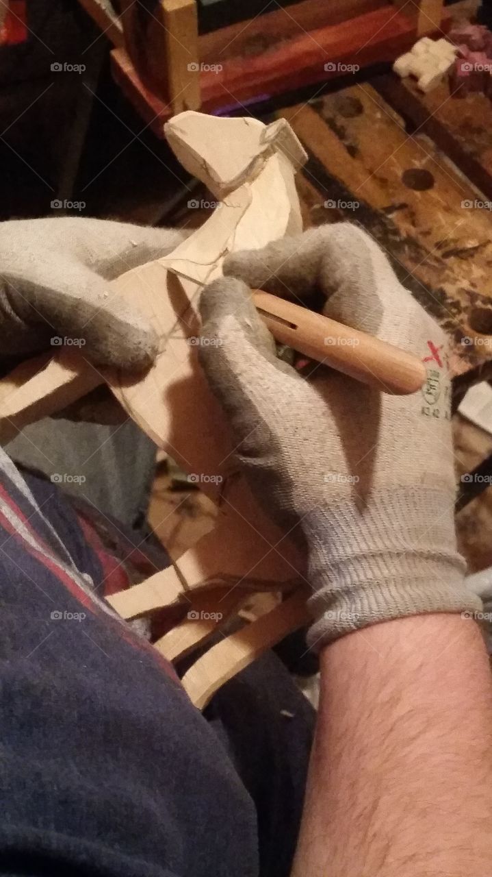 My brother is carving a horse from a once solid piece of wood
