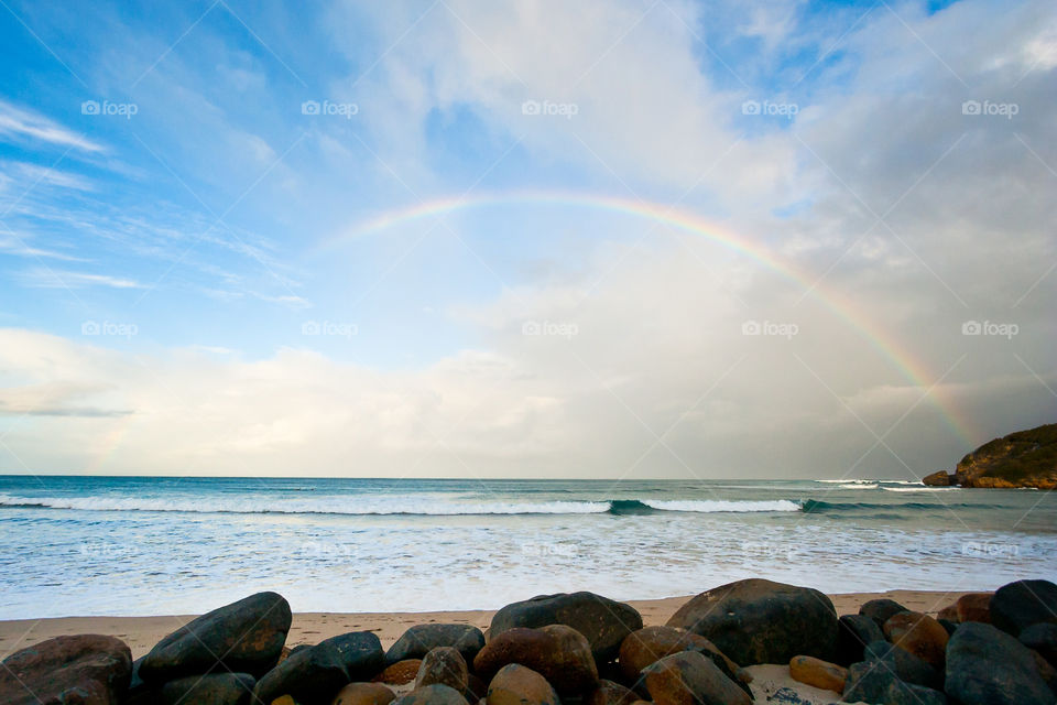 This was the first and only rainbow I have seen over the sea in all its beauty. I love the colors and dreamy look of this image in our beautiful nature. Image in Africa of rainbow over the sea.