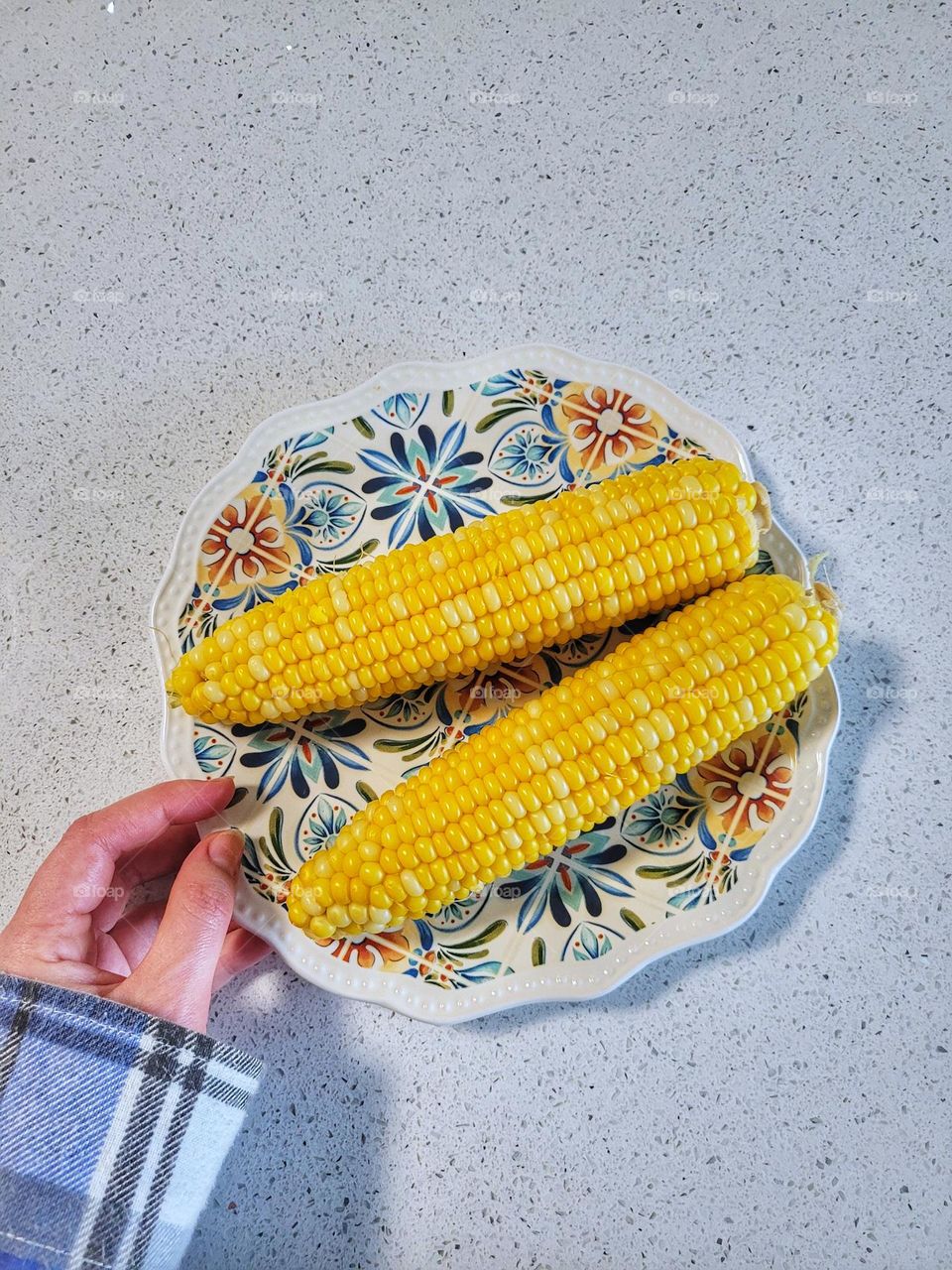 Top view of beautiful plate with two yellow sweetcorns close up. breakfast concept