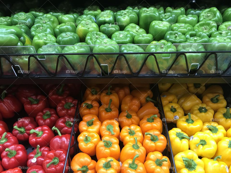 Multiple colors of bell peppers in a row