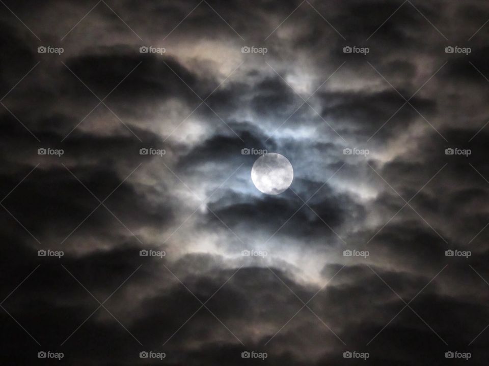 Full moon behind a cloud cover 