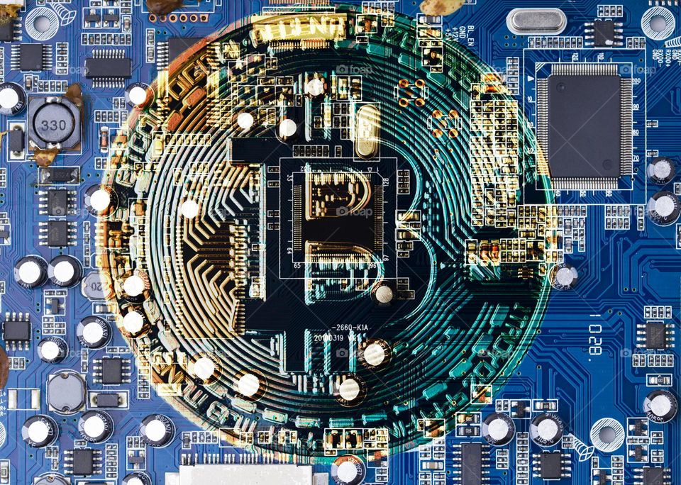 Golden Bitcoin Cryptocurrency on computer circuit board CPU. Mining of crypto-currency concept. Bitcoin logo on circuit board.
