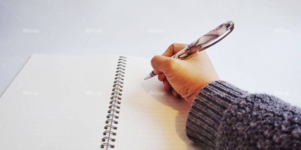 female hand take notes with a pen in notebook