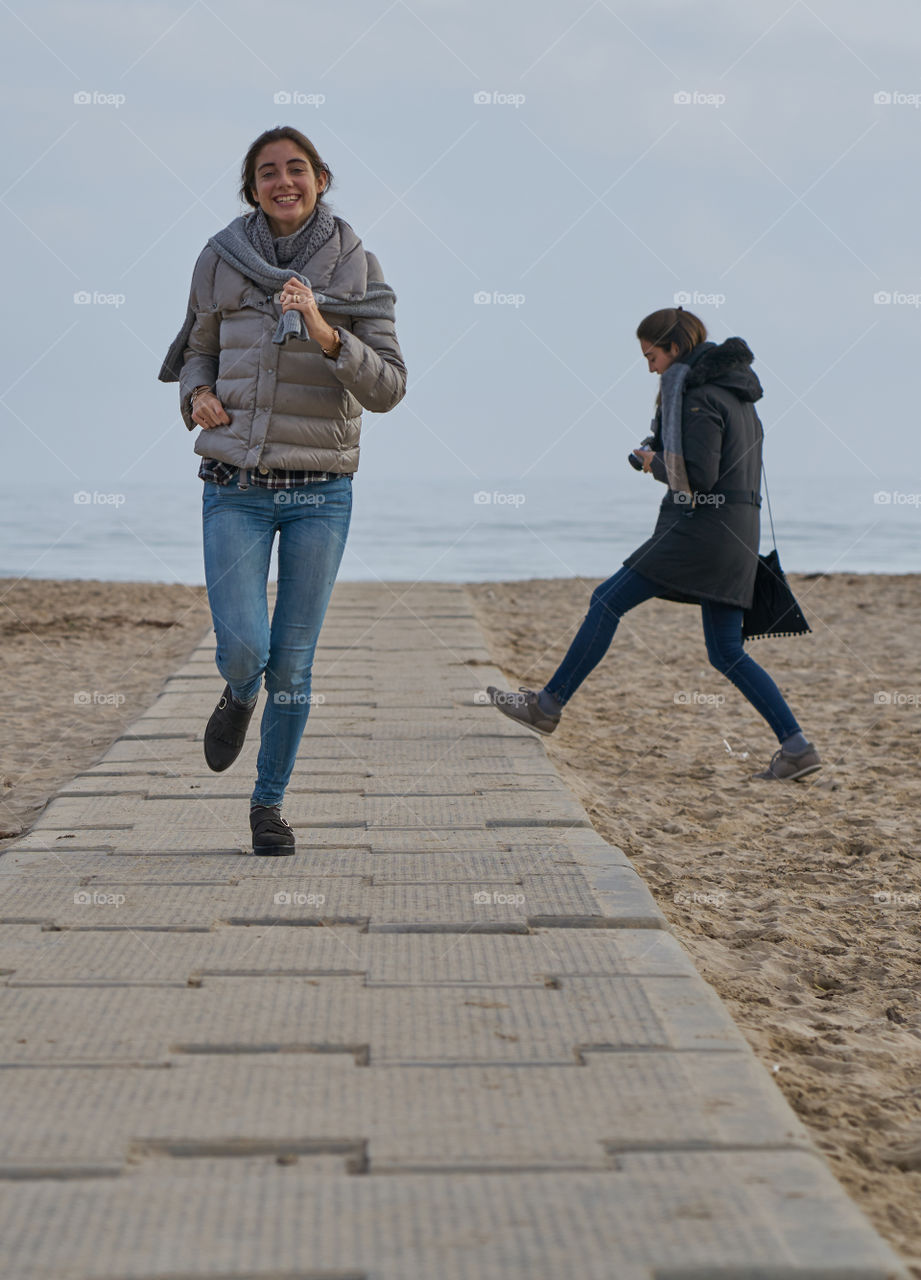 Portrait of young woman walking at beach