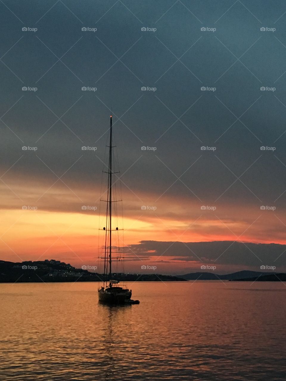 Sailboat sailing in sea during sunset