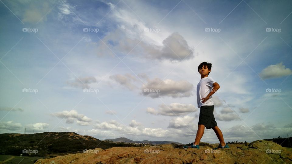 Boy standing on rock