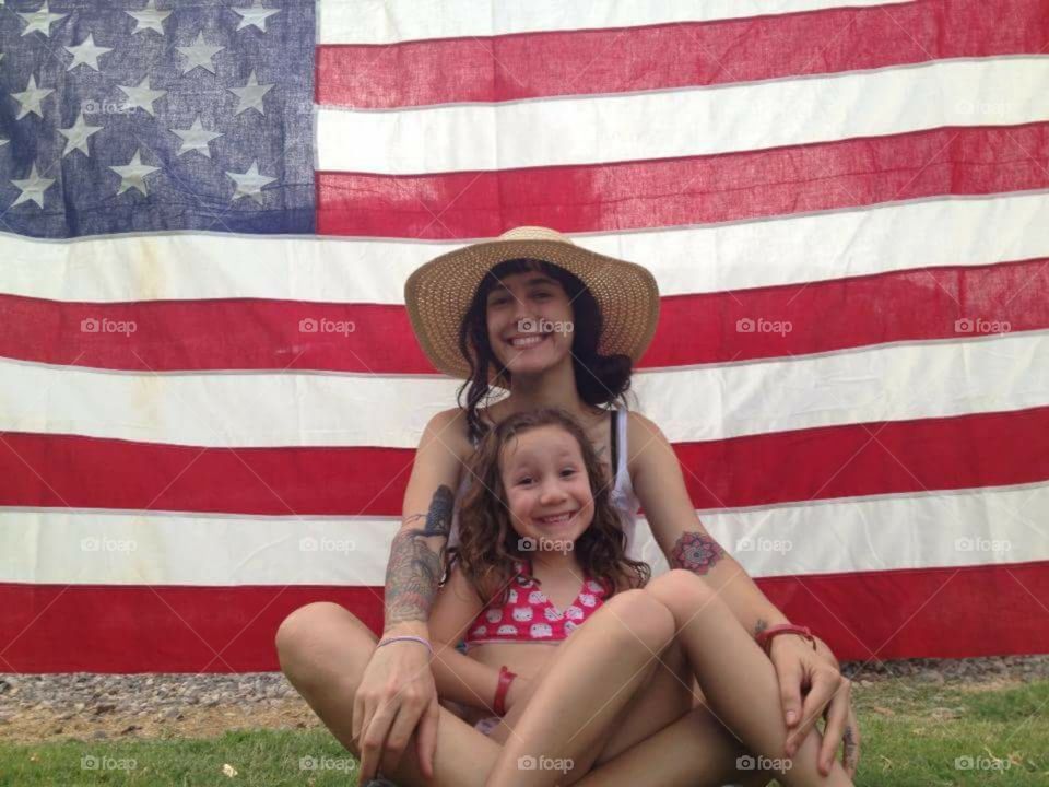 mom American style. mom and daughter in front of ol glory