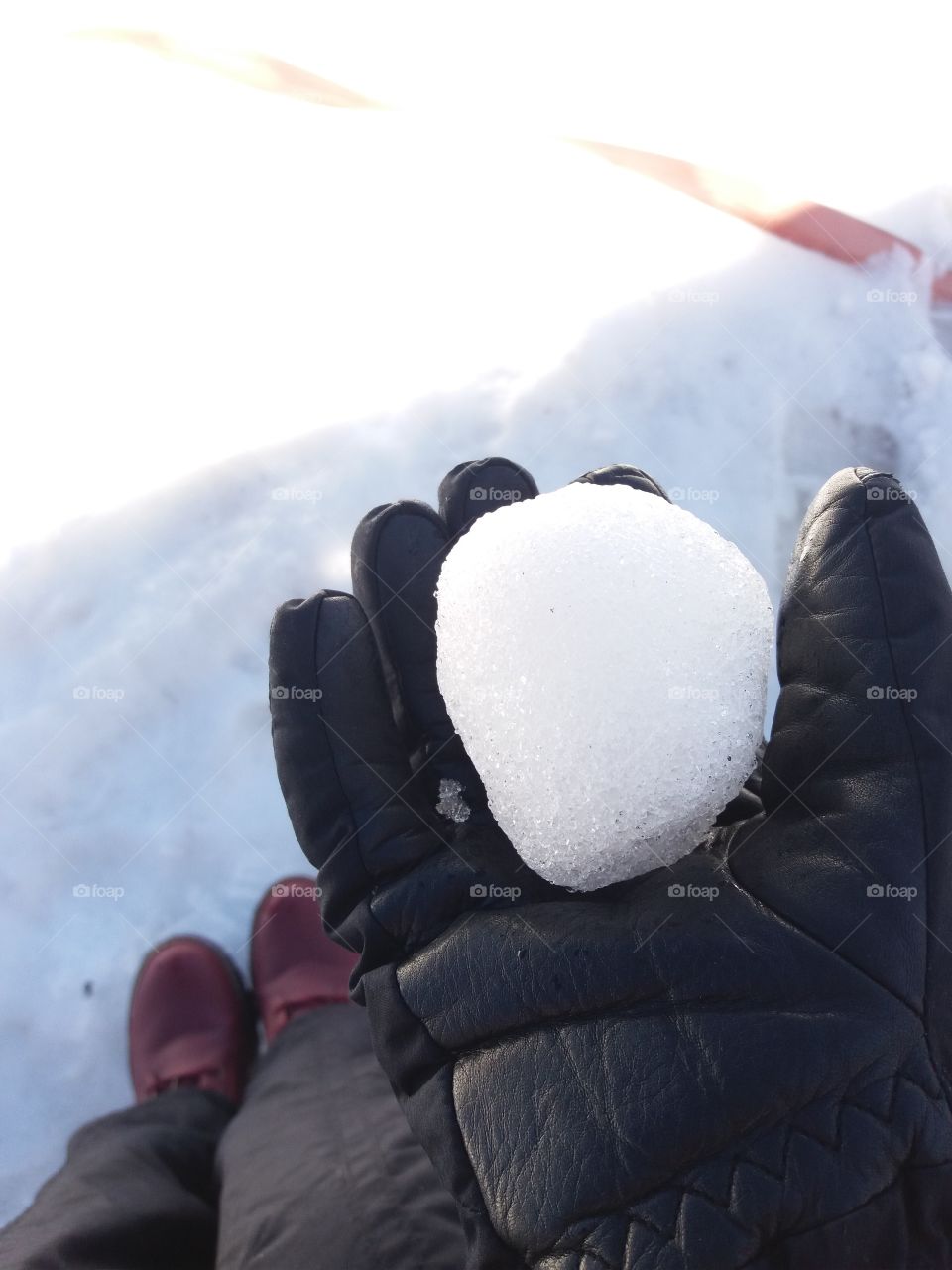 snow ball in a black glove