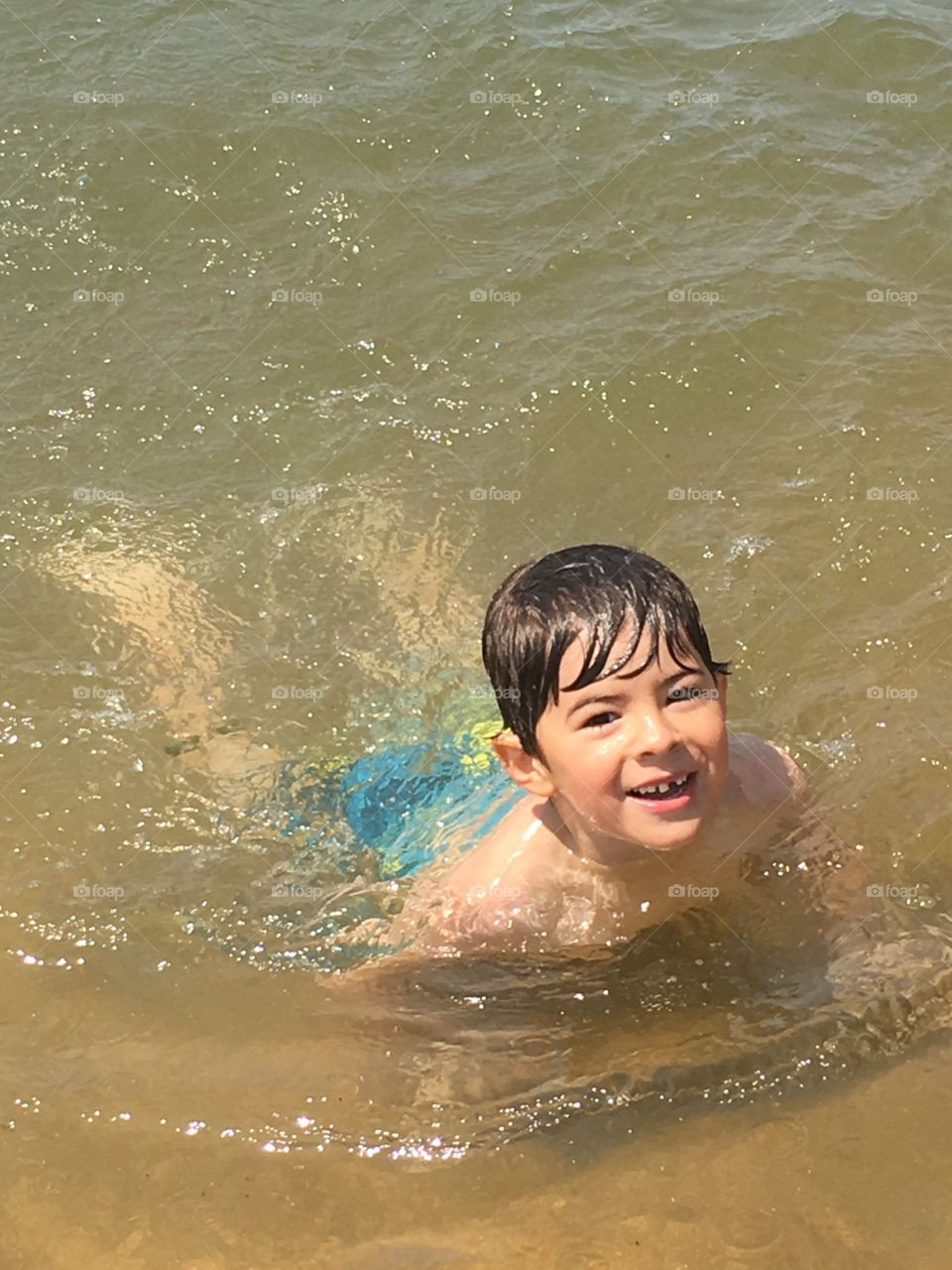 boy swimming in river