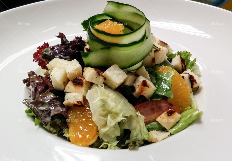 Haloumi salad. Seasonal salad with oranges filets and Haloumi cheese