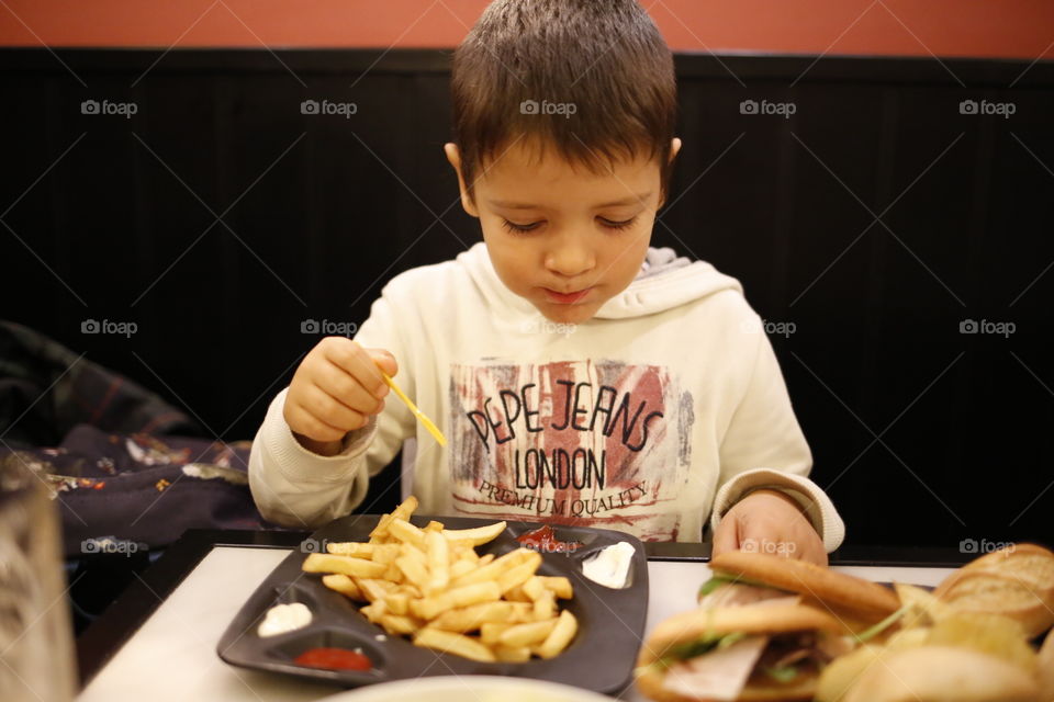 boy eating fries