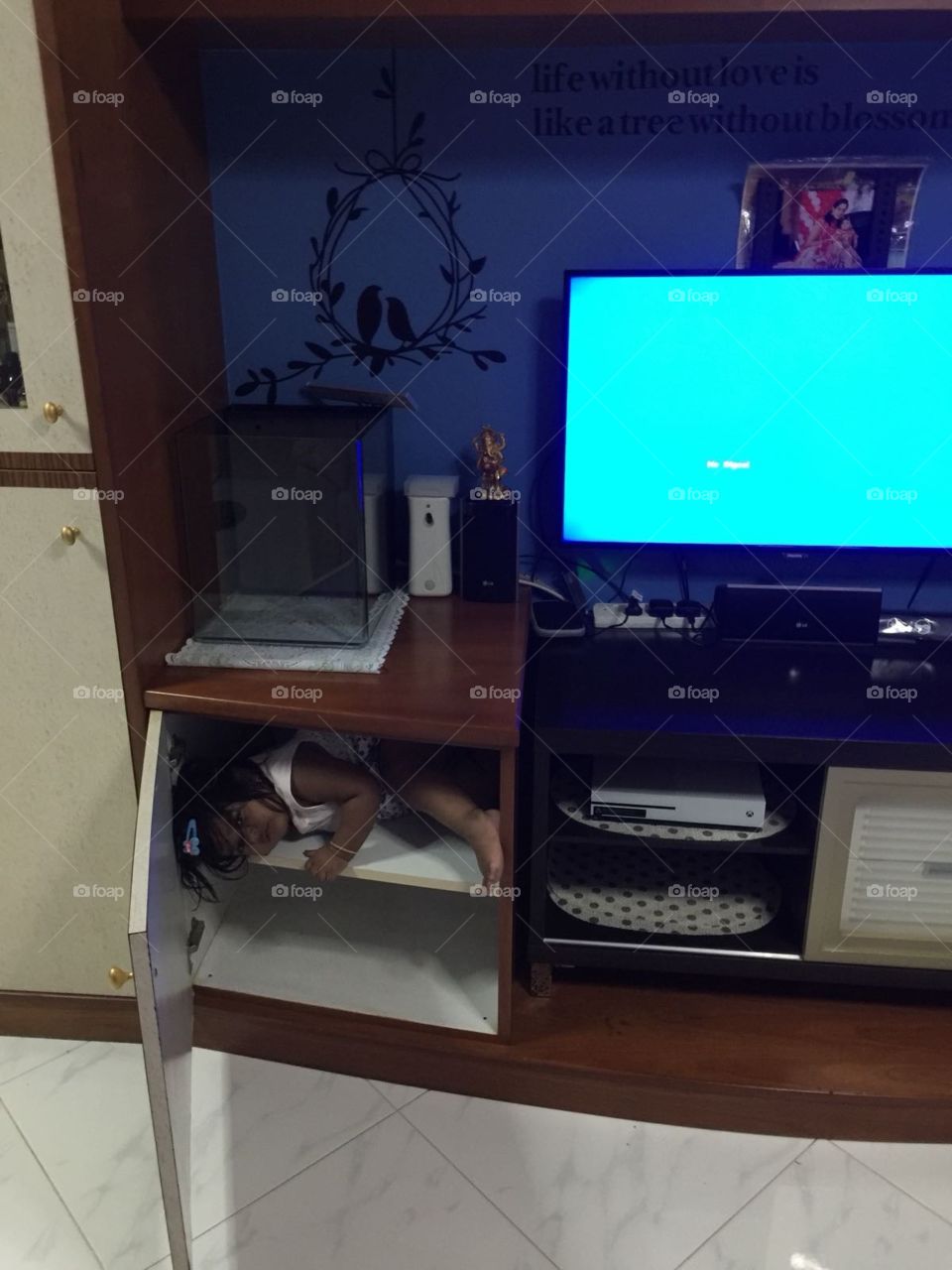 Baby in drawer, playing with mom 