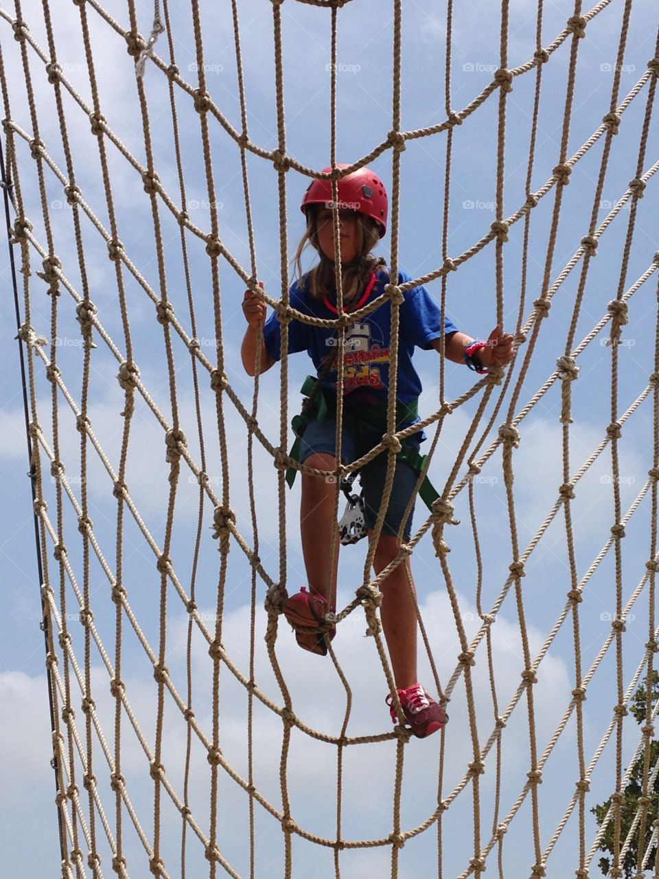 Rope ladder to the sky. Climbing a rope ladder to ride a zipline